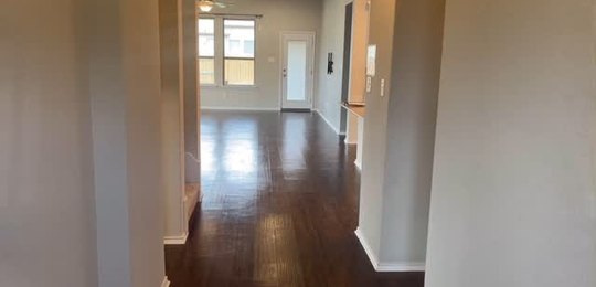 Empty hallway with wood floors