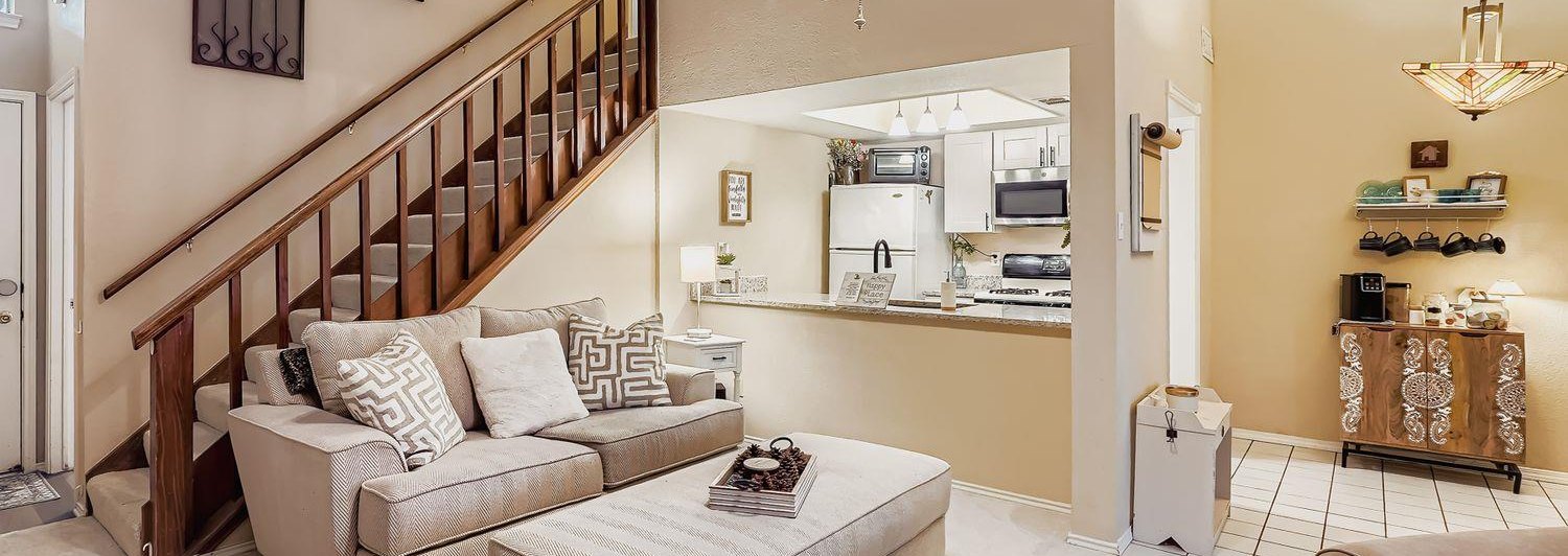 Living room with staircase and open kitchen